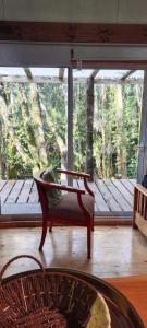 a room with a bench in front of a large window at Refugió Chaicura in Chonchi