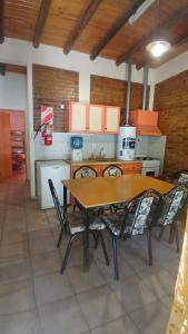 a kitchen with a table and chairs in a room at Cabañas fenix alojamiento in San Rafael