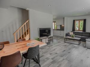 a living room with a wooden table and a couch at Lac Bleu 40 in Lacapelle-Marival
