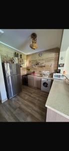 a kitchen with a stainless steel refrigerator and a dishwasher at Lavista 7 in Ain Sokhna