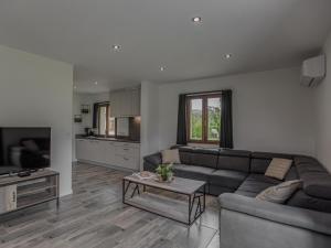 a living room with a couch and a table at Lac Bleu 40 in Lacapelle-Marival