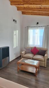 a living room with a couch and a coffee table at Loft en las Sierras in Villa Giardino