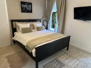 a bedroom with a bed with a television on the wall at Bedroom with extension on Veranda in Yvoir