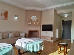 a living room with a couch and a tv at Riviera Beach in Cabo Negro