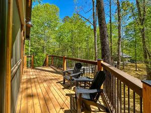 two chairs sitting on a porch of a house at Hot Tub Cabin + Screened Porch | Red River Gorge in Beattyville