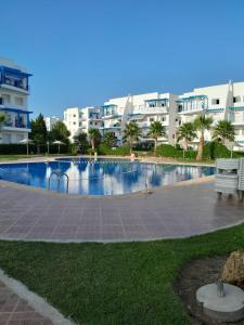 a swimming pool in front of some apartment buildings at Riviera Beach in Cabo Negro