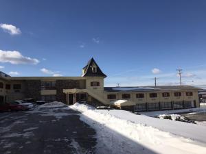 a snow covered parking lot in front of a building at Relax Inn in Wilkes-Barre