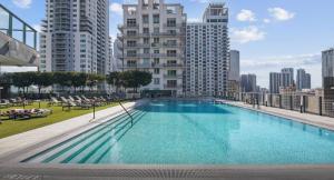 a large swimming pool on the roof of a building at 29th Floor Balcony Studio Miami Skyline Views in Miami