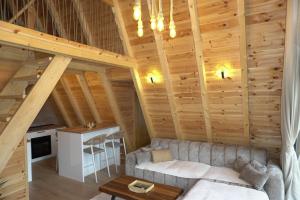 a living room with a couch in a log cabin at Ninas Villas in Vrela