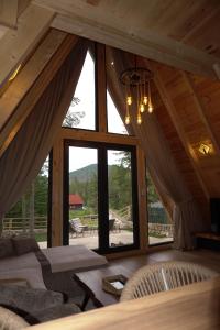a living room with a large window in a cabin at Ninas Villas in Vrela