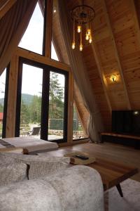 a living room with a couch and a large window at Ninas Villas in Vrela