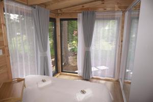 a bedroom with a bed and a large window at Ninas Villas in Vrela +76 photos