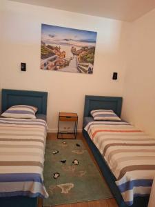 two beds sitting next to each other in a room at Apart sunset in Bar +57 photos