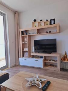 a living room with a television and a table at Apart sunset in Bar
