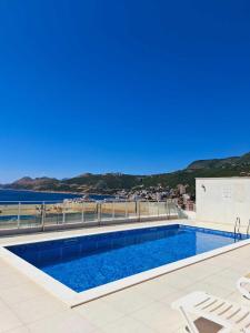 a swimming pool with a view of the water at Apart sunset in Bar