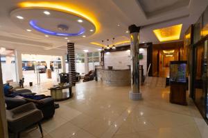 a lobby with couches and a blue ceiling at GLAMOSSAY HOTEL LIMITED SUNYANi in Abesem
