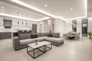 a large living room with a couch and a table at Nimar Villas in Gaïtánion