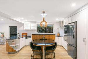 a kitchen with a table and chairs in a room at Salthill in Tweed Heads