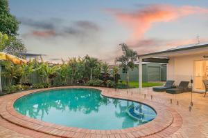 a swimming pool in front of a house at Salthill in Tweed Heads