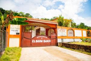 an orange and white building with a brown garage at Boom Ranch in Palmarito