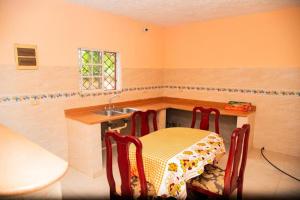 a kitchen with a table and two chairs and a sink at Boom Ranch in Palmarito