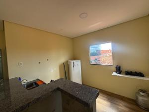 a kitchen with a counter and a refrigerator in a room at Casa da Lu in Barreirinhas +25 photos