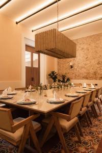a large dining room with a long table and chairs at Casa Chultun Mérida Centro in Mérida