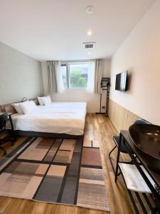 a hotel room with a bed and a sink at Megu Fuji 2021 in Fujiyoshida