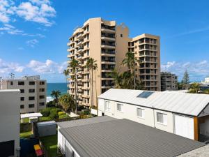 a view of a city with buildings and the ocean at Surf Dance Apartments in Coolum Beach