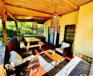 a living room with a couch and a table at Apartamentos El Labrador in Tamarindo