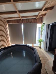 a jacuzzi tub in a living room at Casa da Mexieira em Ponte da Barca in Ponte da Barca