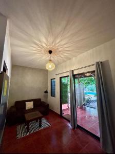 a living room with a couch and a ceiling at Apartamentos El Labrador in Tamarindo