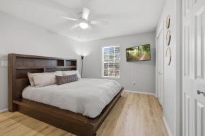 a bedroom with a bed and a ceiling fan at Bed n Bikefast in Bentonville