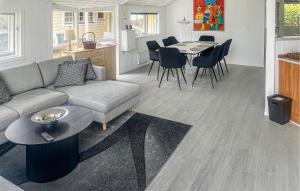 a living room with a couch and a table at 4 Bedroom Cozy Home In Stege in Stege