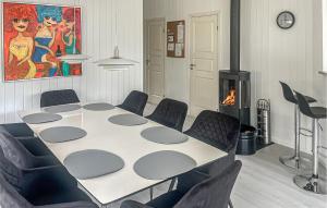a room with a table and chairs and a fireplace at 4 Bedroom Cozy Home In Stege in Stege