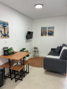 a living room with a couch and a table at Casa Brisa - Las Caracolas in Rio Grande