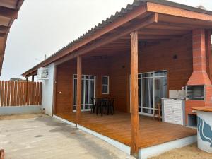 a pavilion with a deck on a house at Casa Brisa - Las Caracolas in Rio Grande