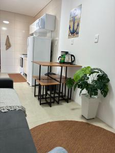 a kitchen with a table and a refrigerator at Casa Brisa - Las Caracolas in Rio Grande +13 photos