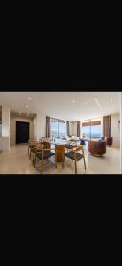 a large living room with a table and chairs at Panorama Villa Infinity Pool in Shëngjin
