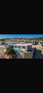 a building on the beach with a swimming pool at Panorama Villa Infinity Pool in Shëngjin