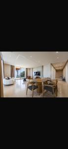 a large living room with a table and chairs at Panorama Villa Infinity Pool in Shëngjin