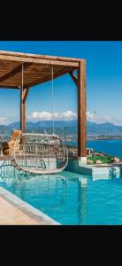 a swimming pool with a view of the water at Panorama Villa Infinity Pool in Shëngjin