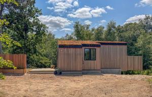 a small wooden building with a grass roof at Amazing Home In Grenaa With Kitchen in Grenå +13 photos