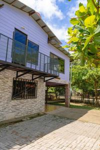 a house with a balcony on top of it at Almendro house playa Panamá in Playa Panama