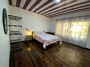 a bedroom with a bed in a room with a window at Almendro house playa Panamá in Playa Panama +10 photos