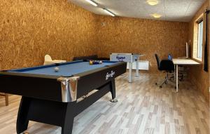 a office with a pool table in a room at Holiday Home Blåbærvangen V in Oxbøl +23 photos