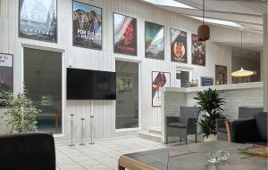 a restaurant with a wall with posters on it at Holiday Home Blåbærvangen V in Oxbøl