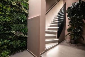a staircase in a building with plants at Corsaro Etna Palace in Motta SantʼAnastasia