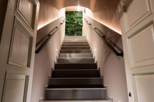 a staircase in a house with stairs leading up to a door at Corsaro Etna Palace in Motta SantʼAnastasia