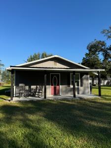a small house with a red door in a field at Cherry Cottage in Lake City +22 photos